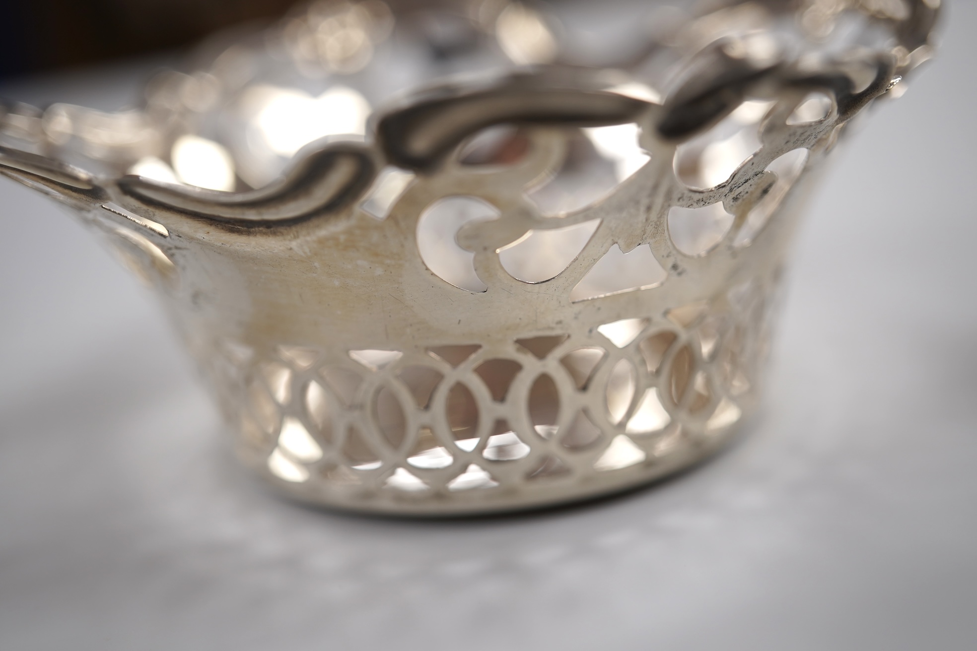 A group of small silver including a modern mounted wine coaster by M C Hersey & Son Ltd, diameter 12.6cm, a set of three George V nut dishes, one other silver nut dish, two pairs of salts including cauldron by William Hu